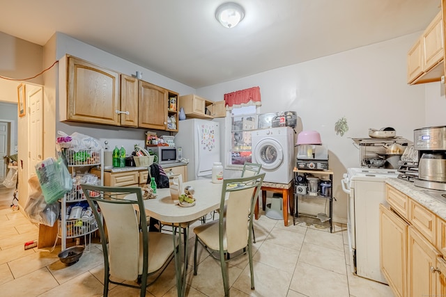 6 Grove Ct, Waterbury, CT 06710 - kitchen with washer / clothes dryer, freestanding refrigerator, light countertops, light tile patterned flooring, and light brown cabinetry