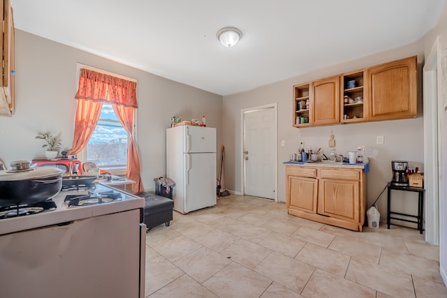 kitchen featuring light tile patterned floors and white appliances