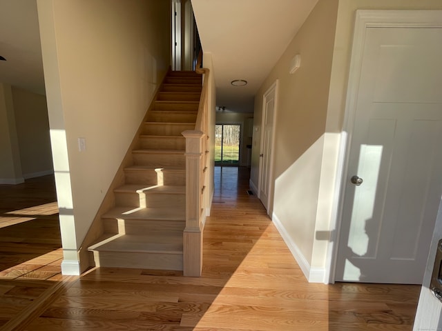 stairs featuring hardwood / wood-style floors