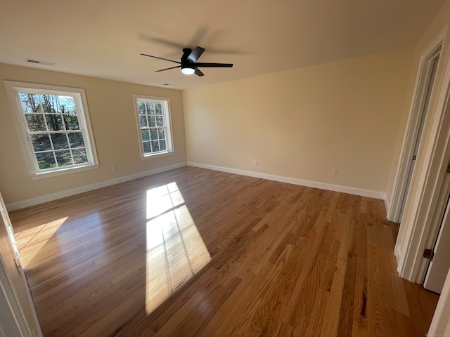 spare room with ceiling fan and light wood-type flooring