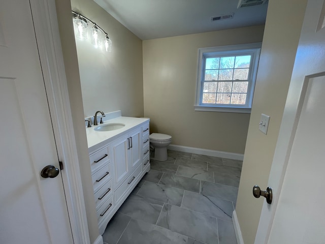 bathroom featuring vanity and toilet