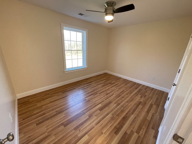 unfurnished room with hardwood / wood-style floors and ceiling fan