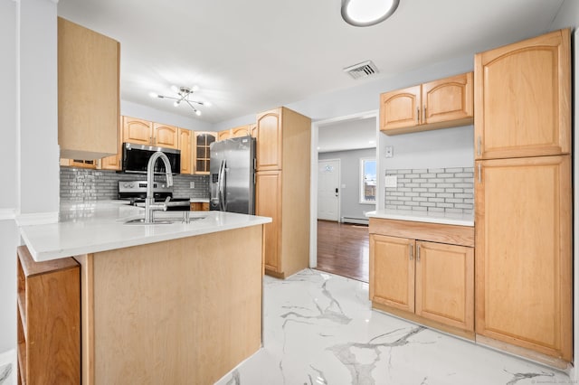 kitchen featuring appliances with stainless steel finishes, backsplash, sink, and light brown cabinets