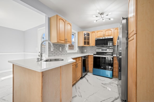 kitchen with stainless steel range with electric cooktop, sink, light brown cabinets, tasteful backsplash, and kitchen peninsula