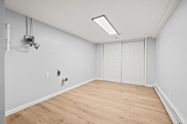 interior space featuring wood-type flooring and baseboard heating