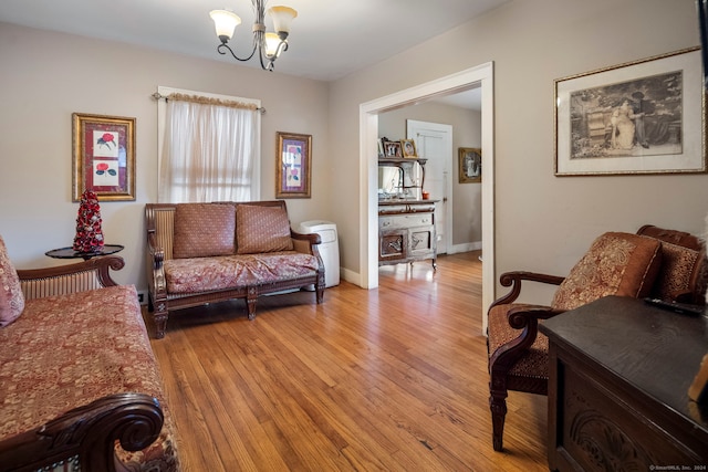 living room with a chandelier and light wood-type flooring