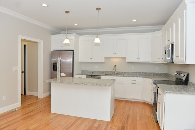 kitchen featuring a kitchen island, sink, white cabinetry, and stainless steel appliances