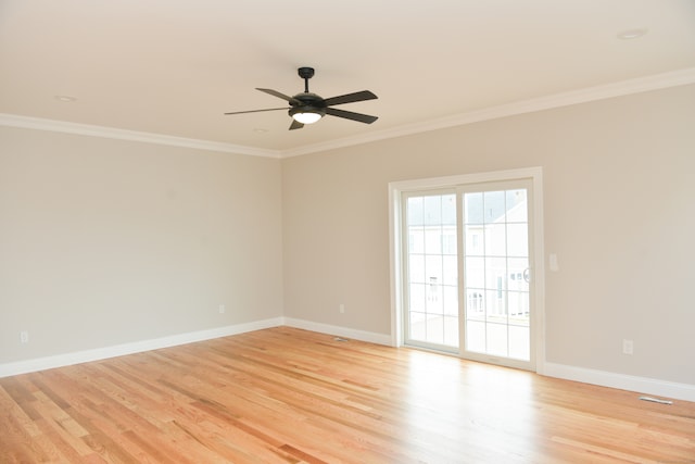 spare room with ornamental molding and light hardwood / wood-style flooring