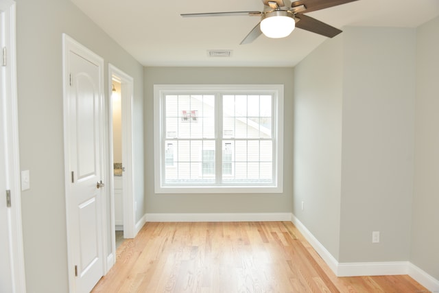 spare room with light wood-type flooring and ceiling fan