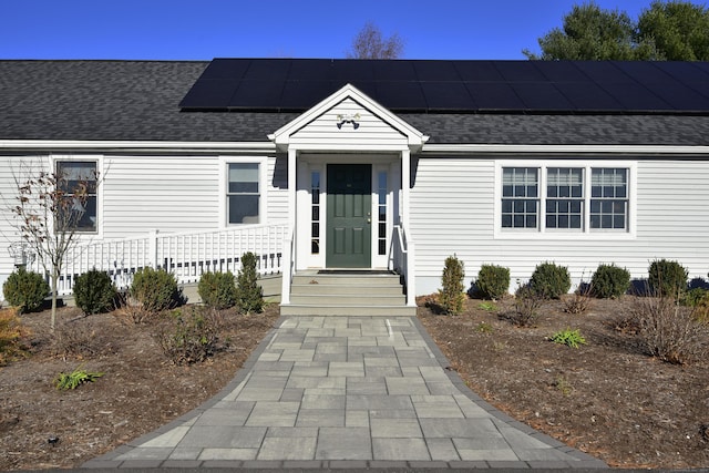 view of front of house featuring solar panels