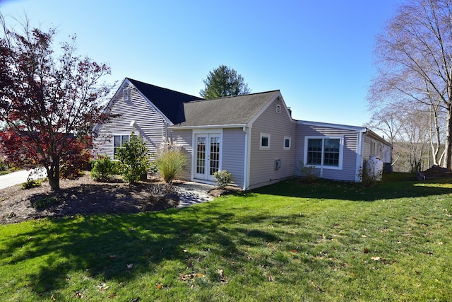 back of house featuring a yard and french doors