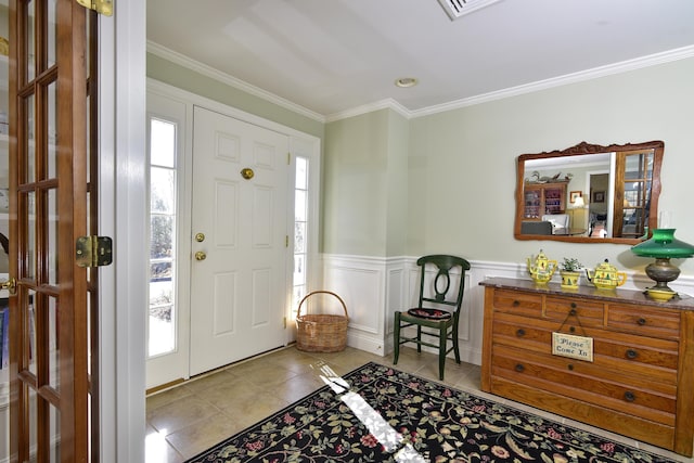 foyer with plenty of natural light, light tile patterned flooring, and ornamental molding