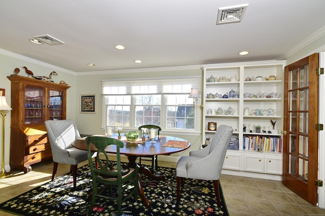 tiled dining room with crown molding and french doors