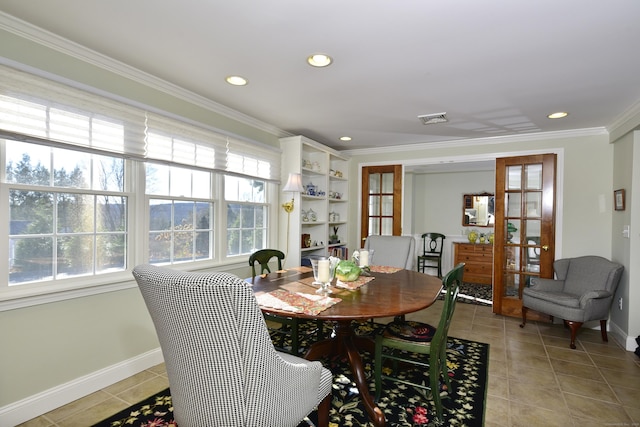 tiled dining room with crown molding and french doors