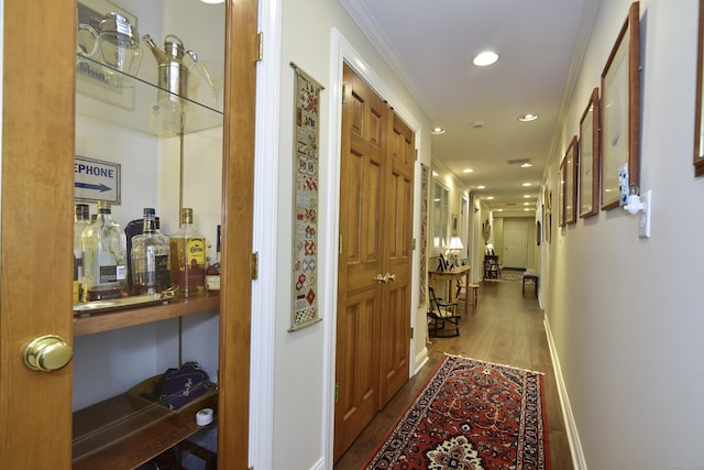 hall featuring dark hardwood / wood-style flooring and crown molding