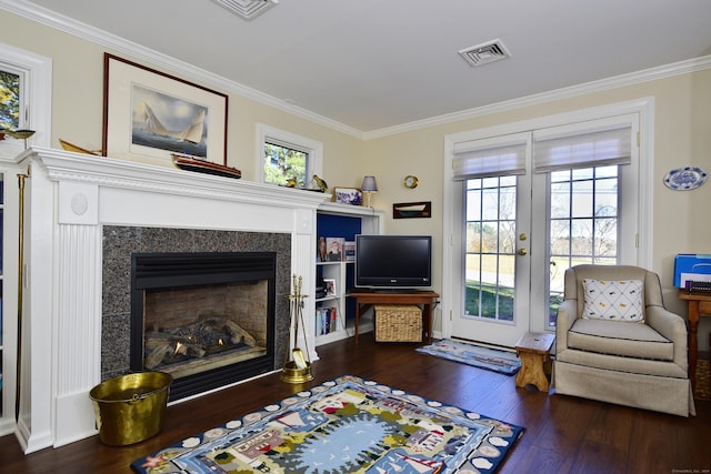 living area with crown molding and dark hardwood / wood-style flooring