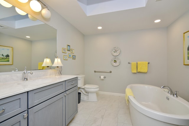 bathroom with a tub, vanity, and toilet