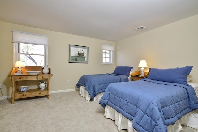 carpeted bedroom with multiple windows