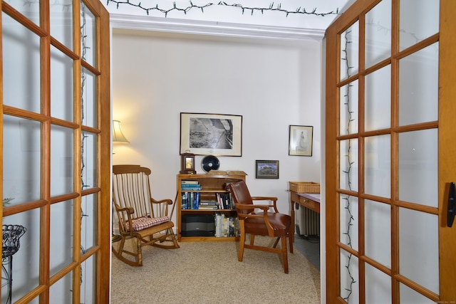 sitting room with carpet flooring and french doors