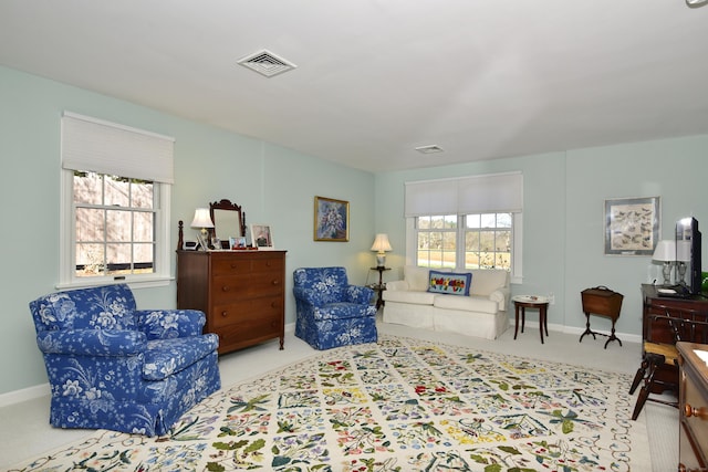 sitting room with a healthy amount of sunlight and light colored carpet