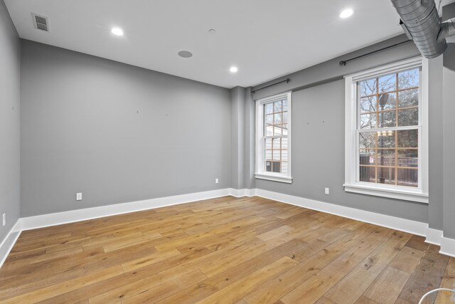 spare room featuring light wood-type flooring