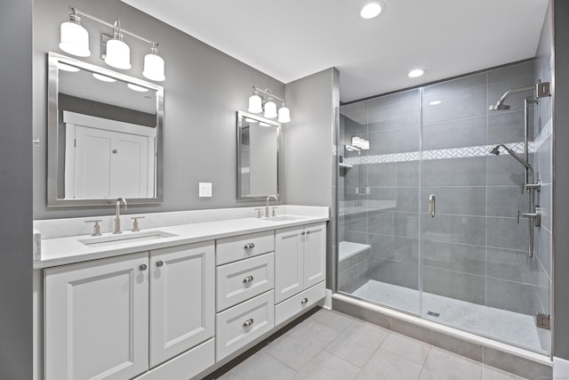 bathroom featuring walk in shower, vanity, and tile patterned flooring