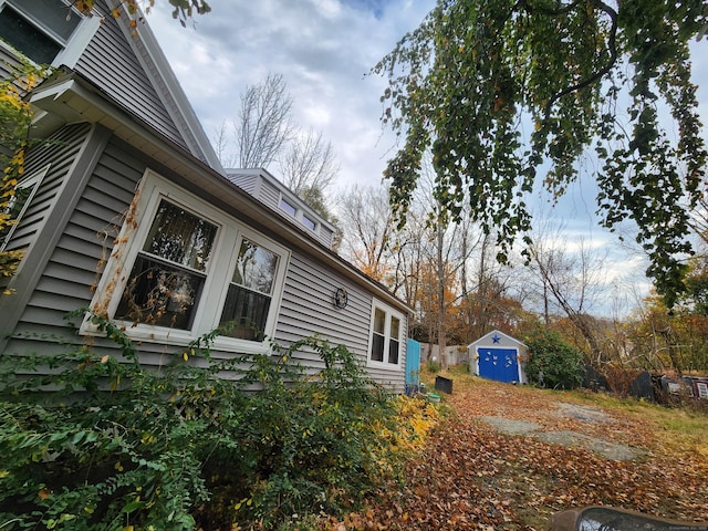 view of home's exterior with a shed