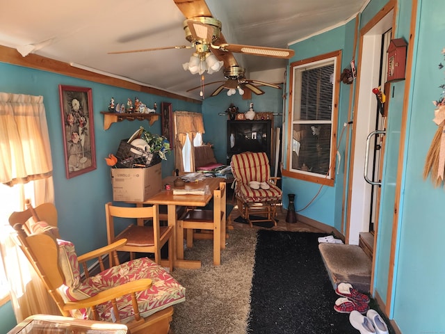 living area featuring ceiling fan and carpet floors