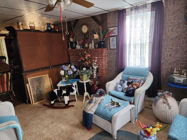 sitting room with carpet flooring, a paneled ceiling, and a healthy amount of sunlight