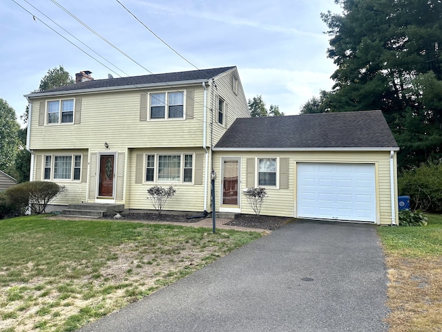 view of front of house featuring a garage and a front yard