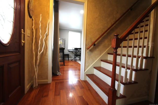 foyer with hardwood / wood-style floors and crown molding