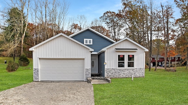 view of front of home with a front yard and a garage