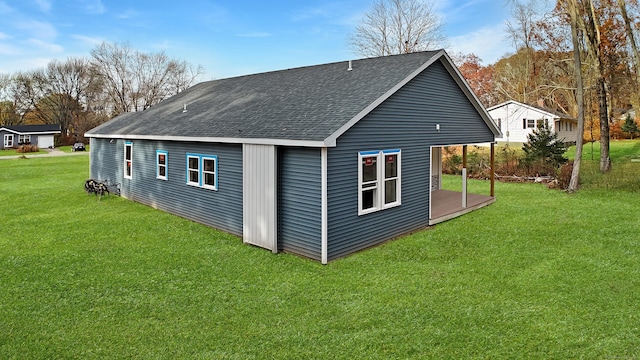 rear view of property featuring a yard and a wooden deck