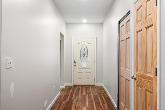 entryway with dark hardwood / wood-style flooring