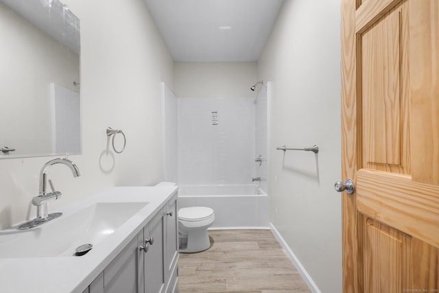 full bathroom featuring hardwood / wood-style floors, vanity, toilet, and shower / tub combination