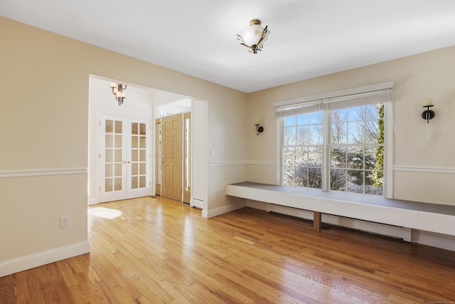 interior space with light wood-type flooring and a baseboard radiator