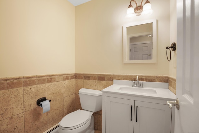 bathroom featuring tile walls, toilet, and vanity