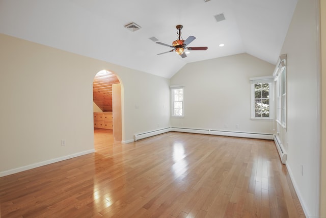 empty room featuring ceiling fan, a baseboard heating unit, light hardwood / wood-style flooring, and vaulted ceiling