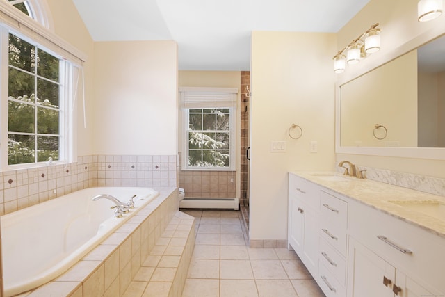 bathroom with a wealth of natural light, baseboard heating, and tile patterned flooring