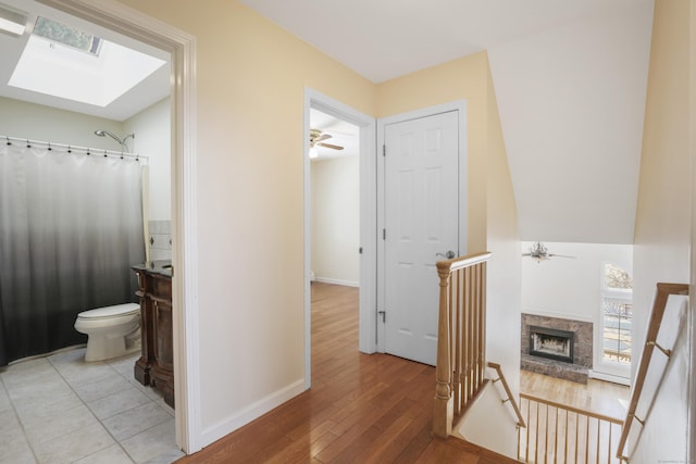 interior space featuring light hardwood / wood-style floors and a skylight