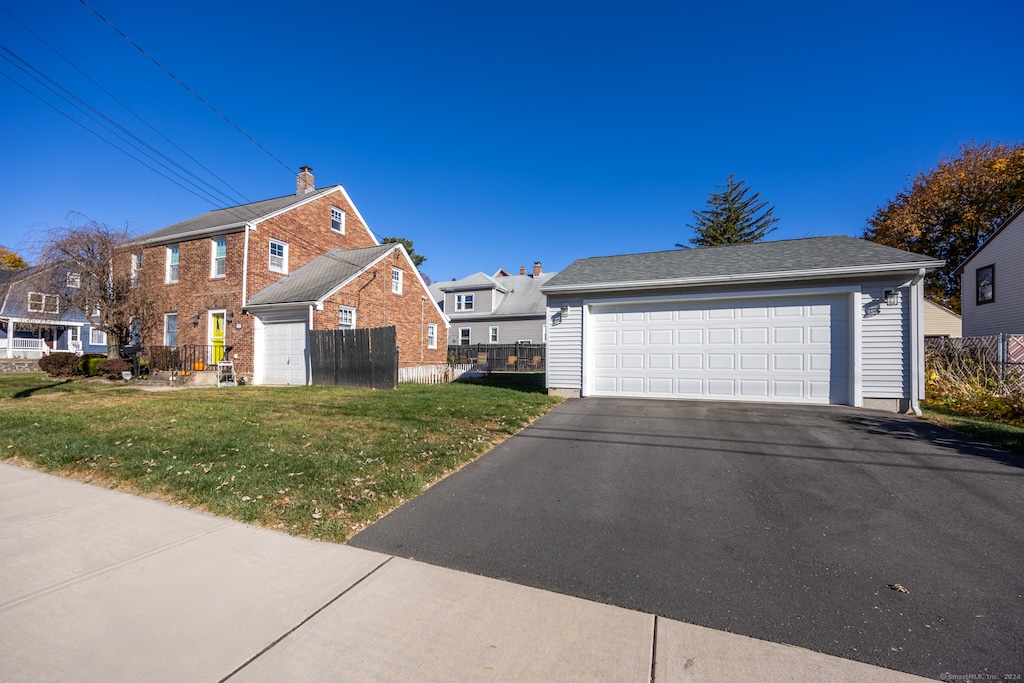 view of home's exterior featuring a yard and a garage