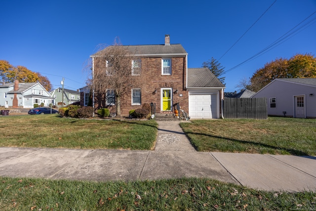 colonial house with a garage and a front yard