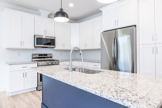 kitchen with light stone countertops, stainless steel appliances, sink, pendant lighting, and white cabinets