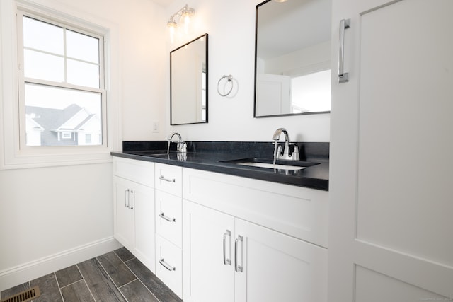 bathroom with vanity and wood-type flooring