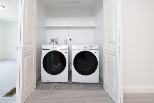 clothes washing area featuring carpet flooring and washer and clothes dryer