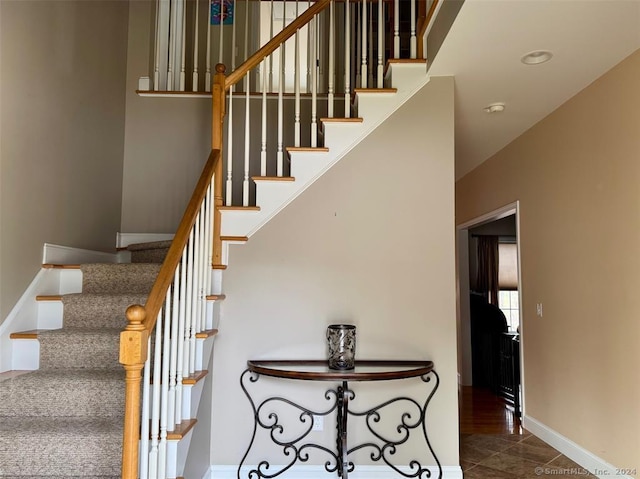 staircase featuring tile patterned floors