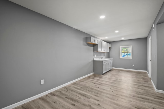 interior space featuring light hardwood / wood-style floors, gray cabinetry, and sink