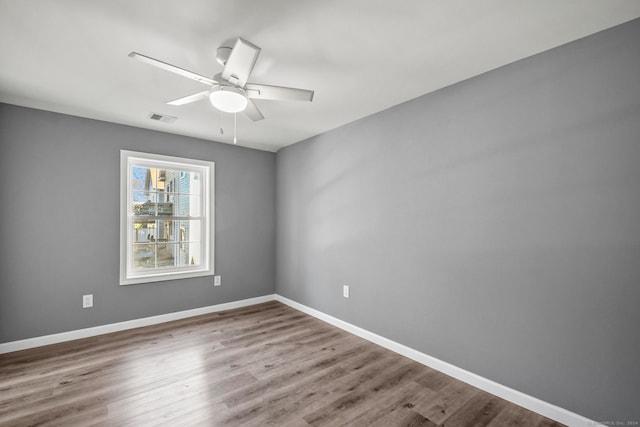 empty room featuring wood-type flooring and ceiling fan