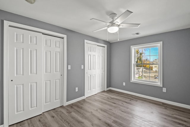 172 Quinnipiac Ave, New Haven, CT 06513 - unfurnished bedroom with two closets, wood finished floors, and a ceiling fan
