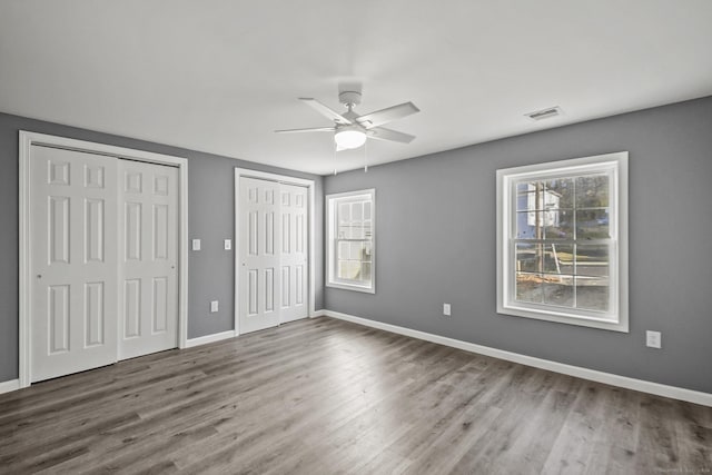 172 Quinnipiac Ave, New Haven, CT 06513 - unfurnished bedroom with two closets, wood finished floors, and a ceiling fan